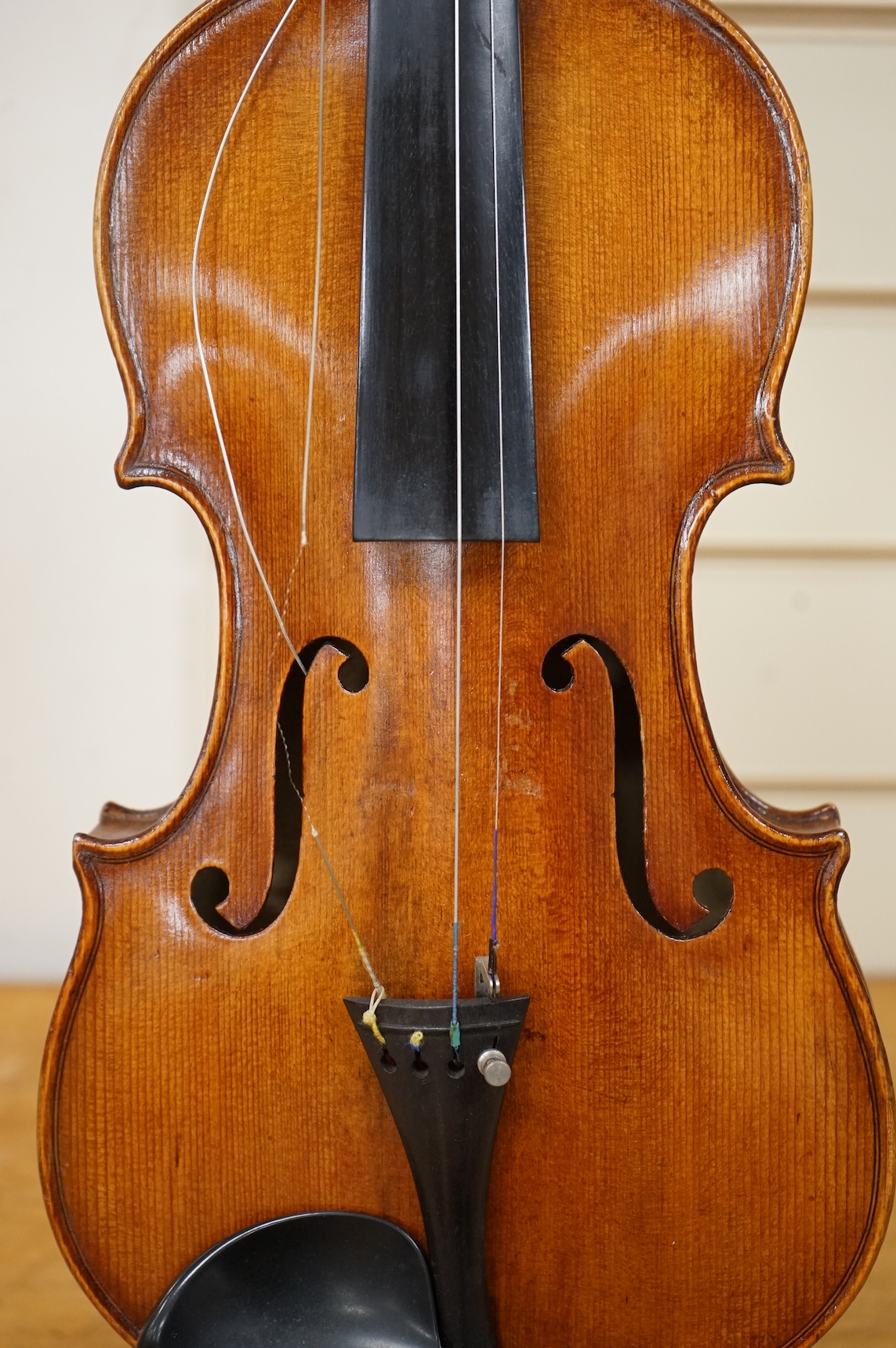 Three violins; a late 19th century German Stradivarius pattern violin, without label, a handmade violin (a.f.), with sound post crack, broken and repaired scroll, etc. and a Maidstone violin body, varnish stripped from t